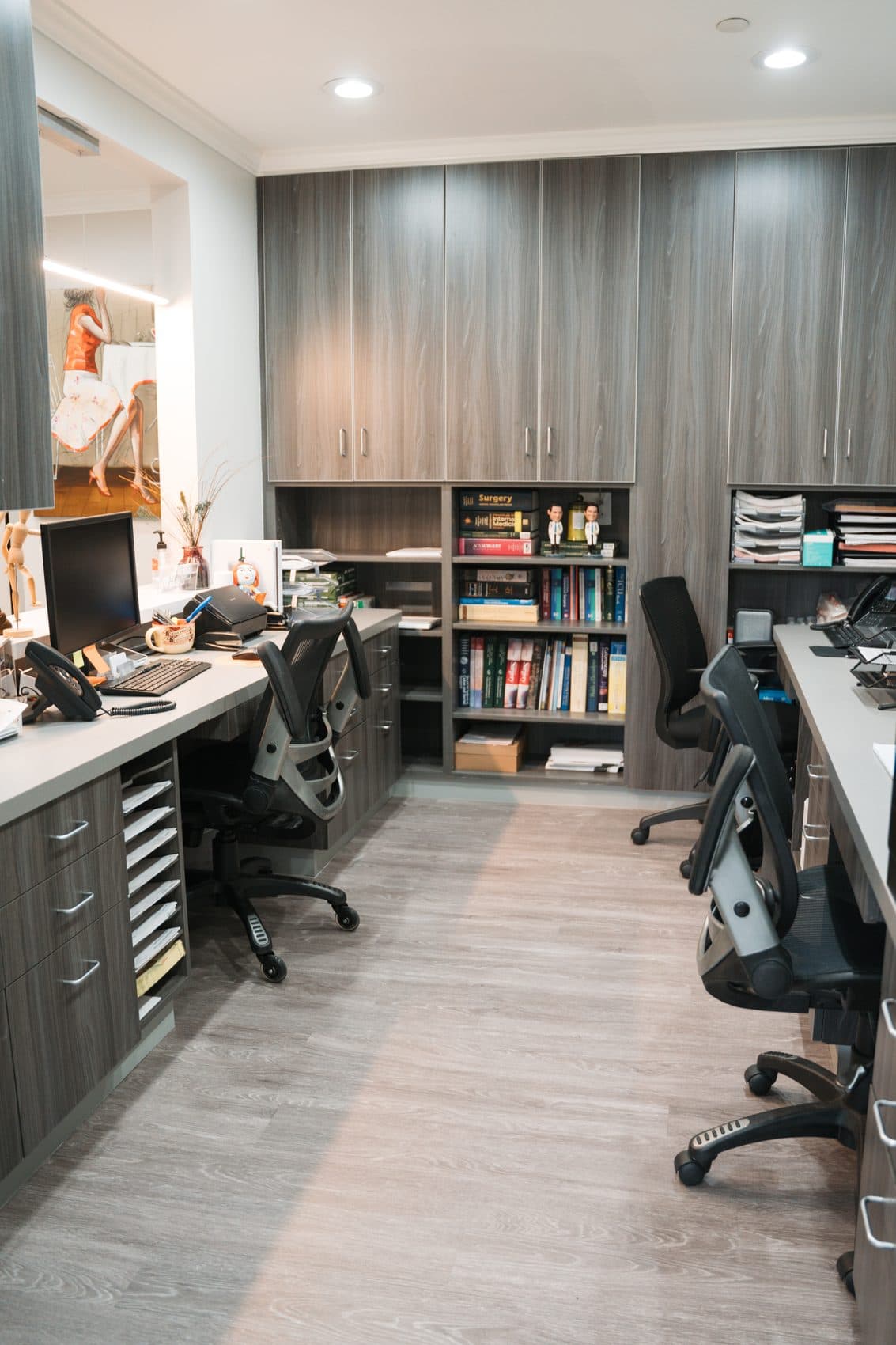 The reference shelf in Dr. Kamrava's office at 435 North Bedford Drive, holding the colon and rectal surgery textbooks the study guides were condensed from